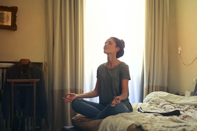 Woman Practicing Meditation at Bedroom